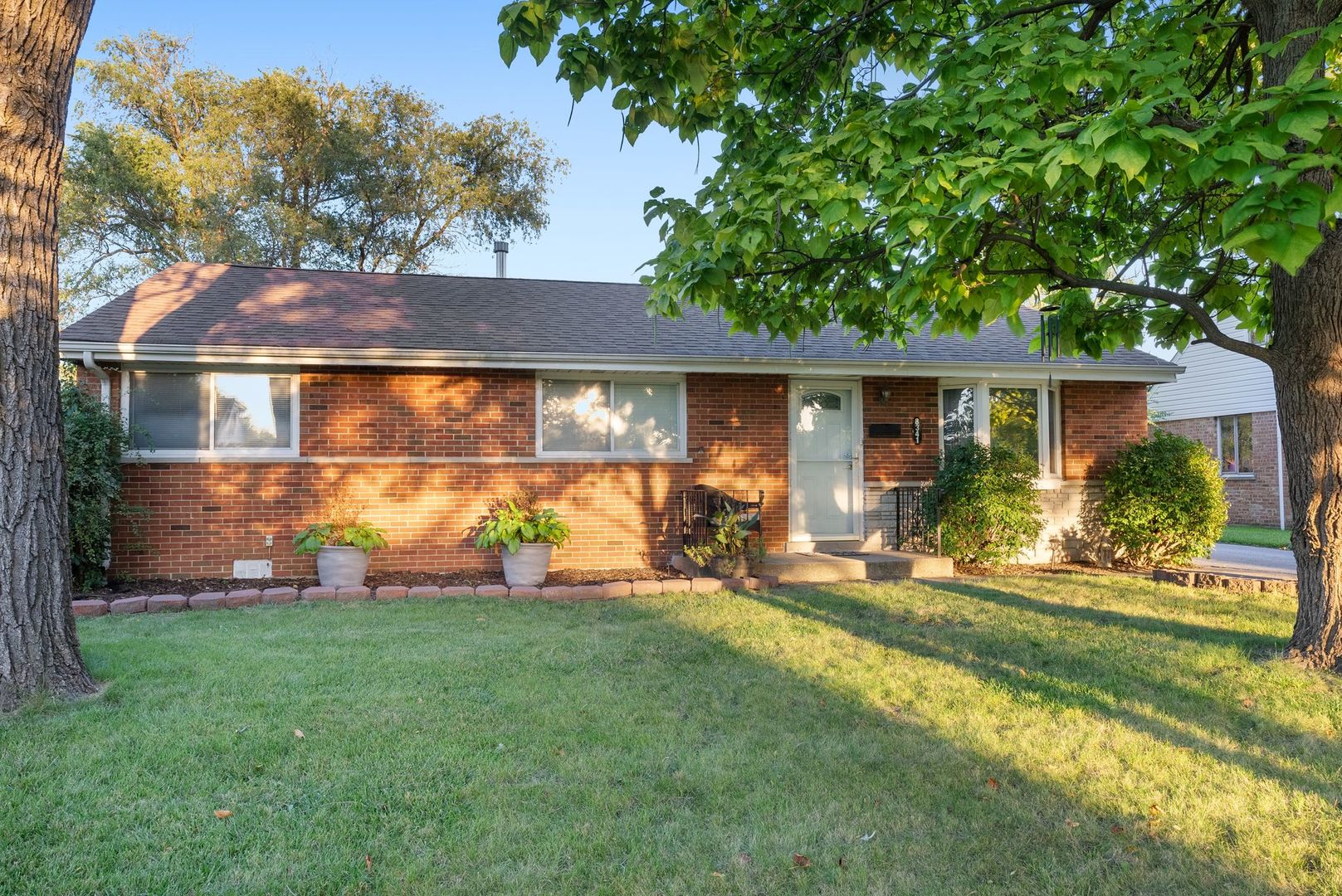 a front view of house with yard and green space