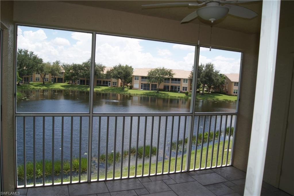 Unfurnished sunroom featuring a water view and ceiling fan