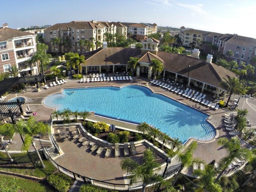 a view of a house with swimming pool and sitting area