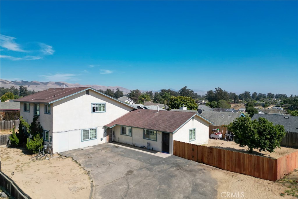 a view of a house with a wooden fence