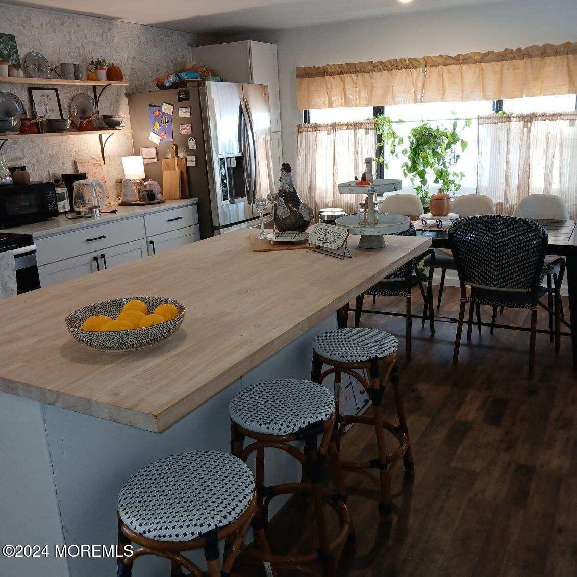 a kitchen with a table chairs stove and kitchen island