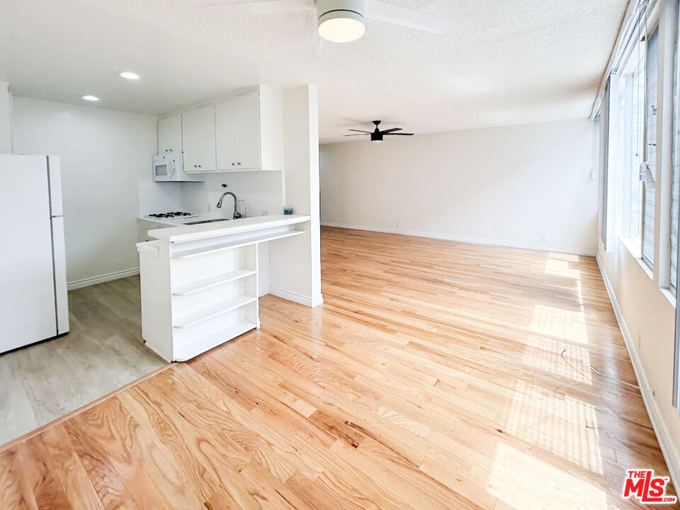 a view of kitchen and empty room