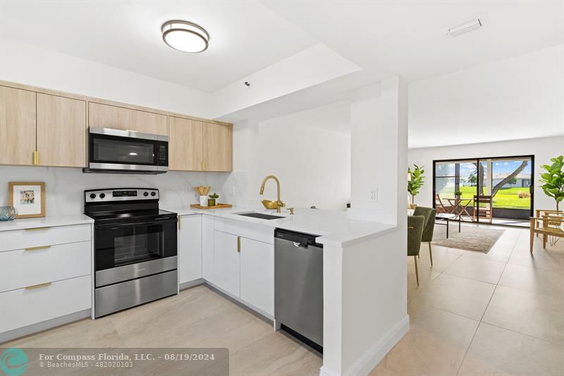 a kitchen with a sink and white cabinets