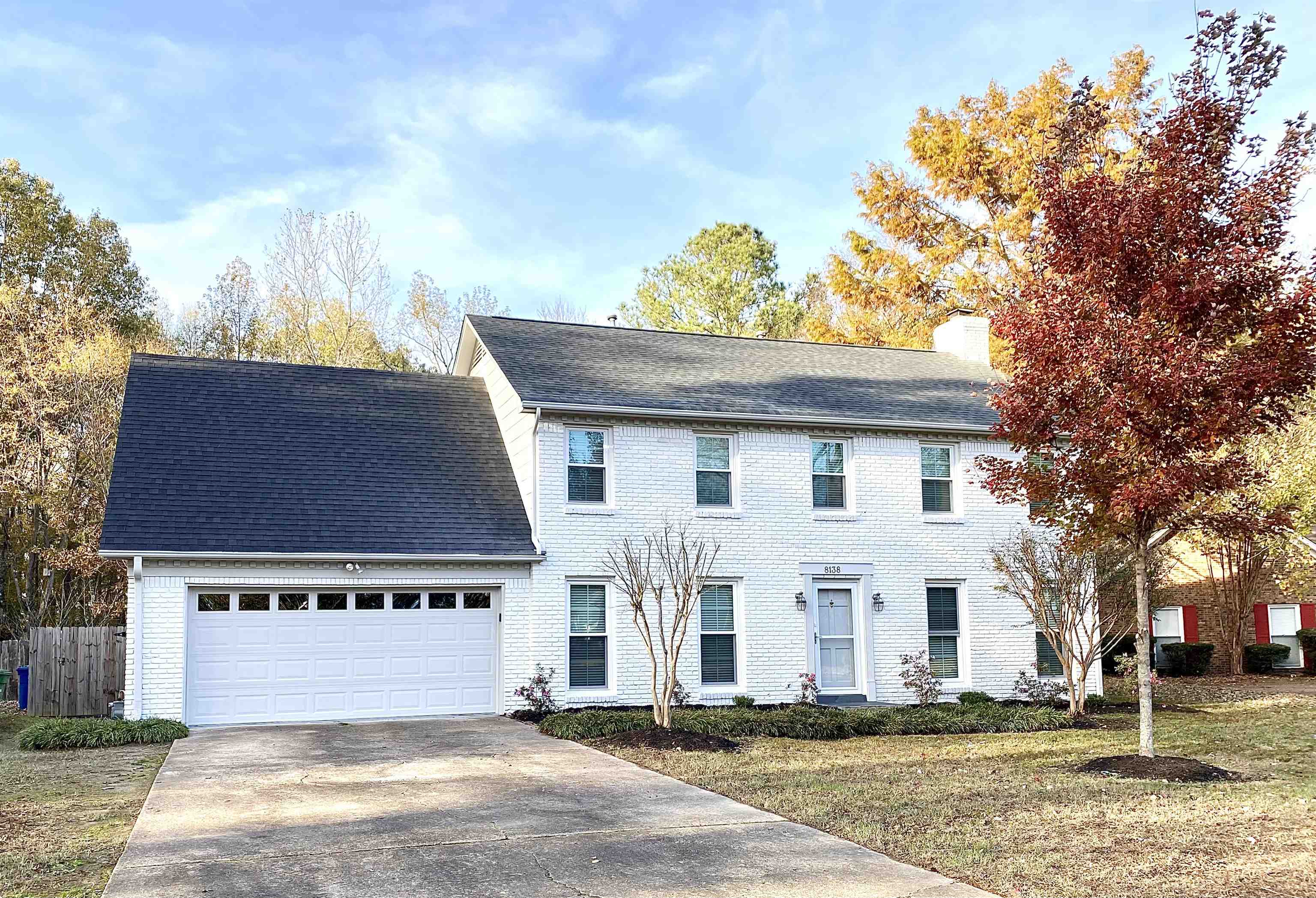 a white house with a sink and yard