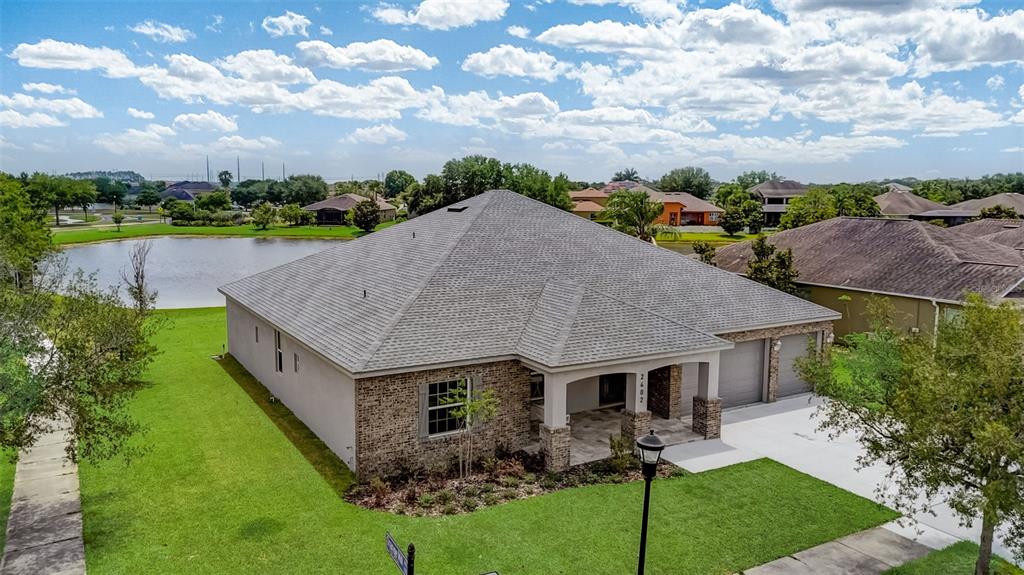 an aerial view of a house with garden space and street view