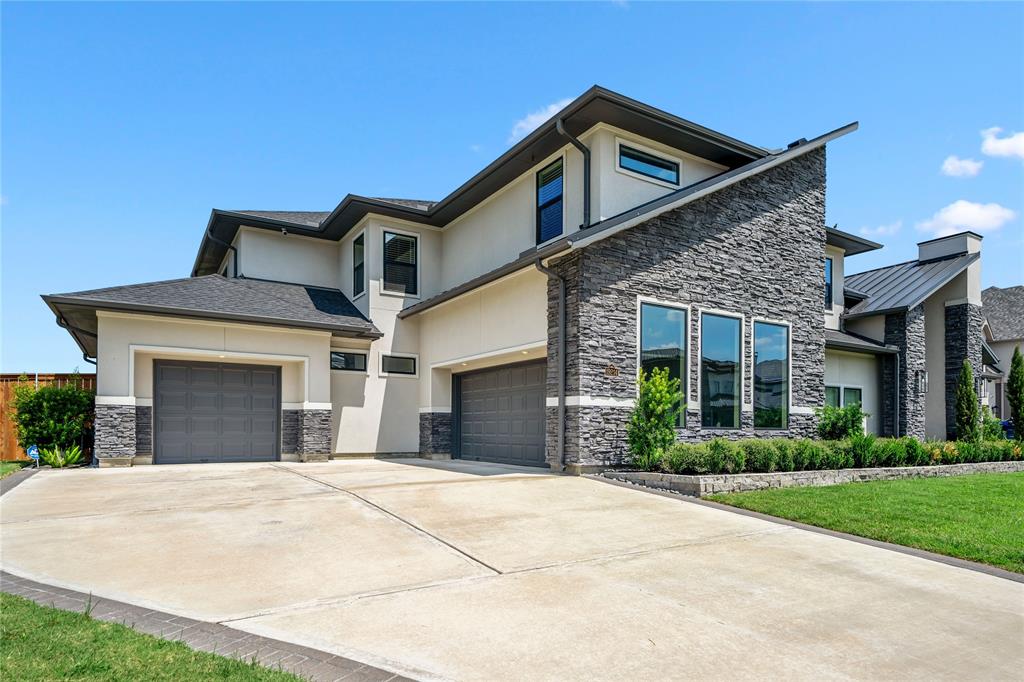 Front view of home with two garages that fit 3 cars comfortably