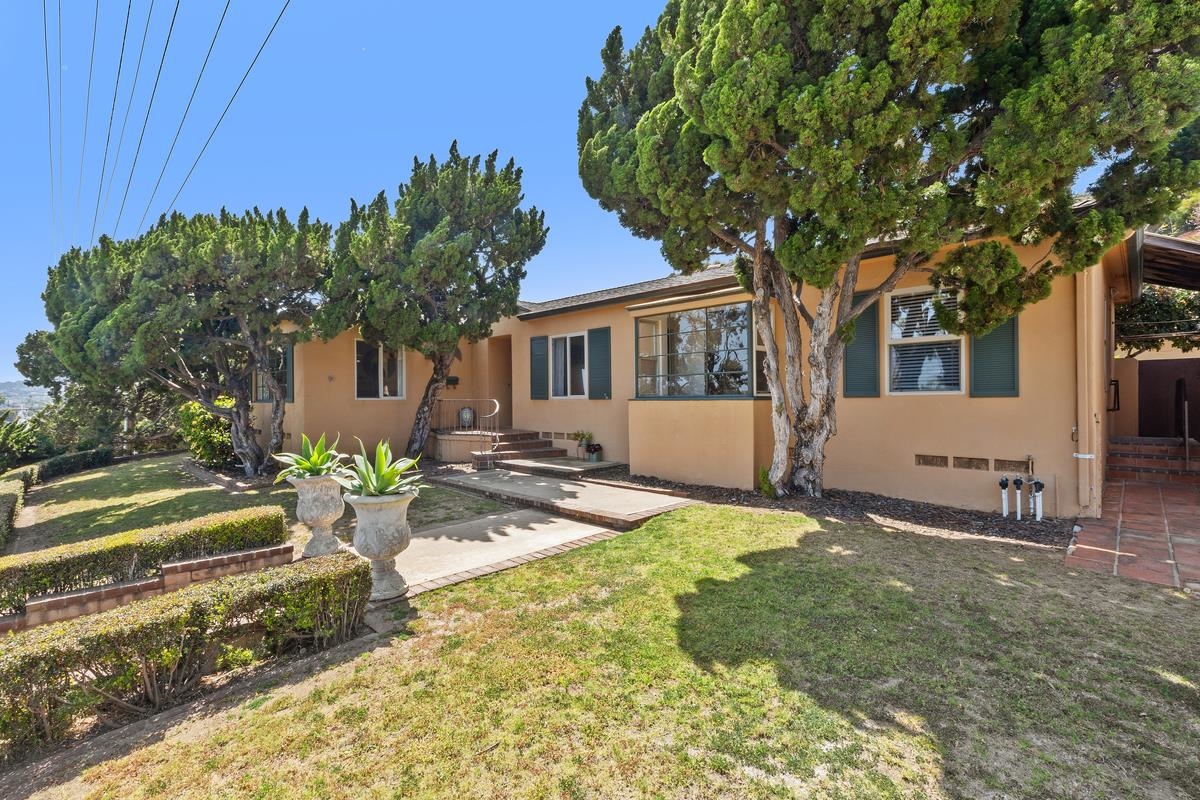 a front view of a house with garden