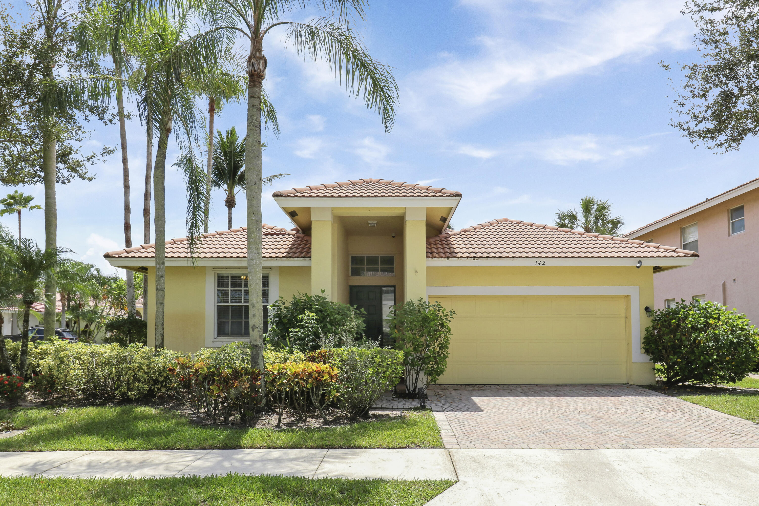 a front view of a house with a garden