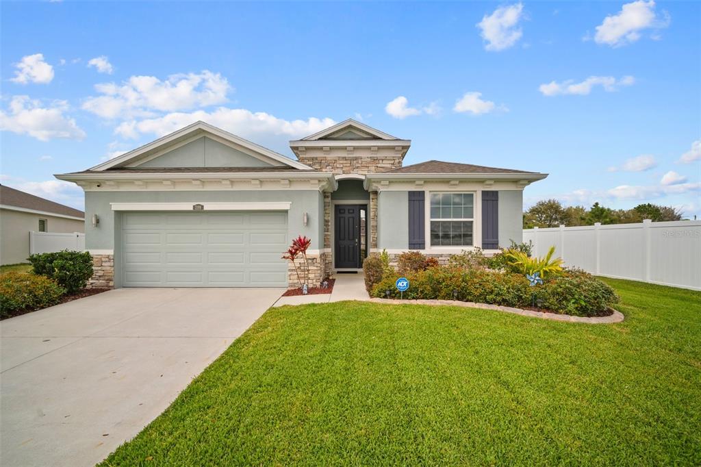 a front view of a house with a yard and garage