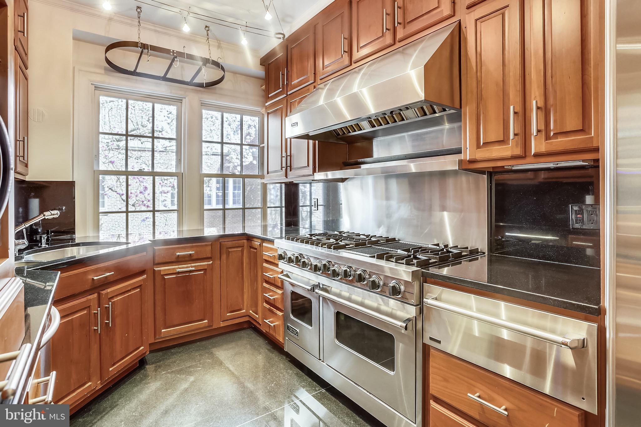 a kitchen with stainless steel appliances granite countertop a stove and a microwave