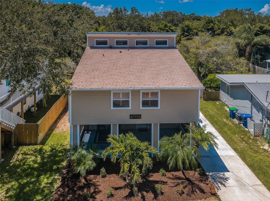 a aerial view of a house with a yard and potted plants