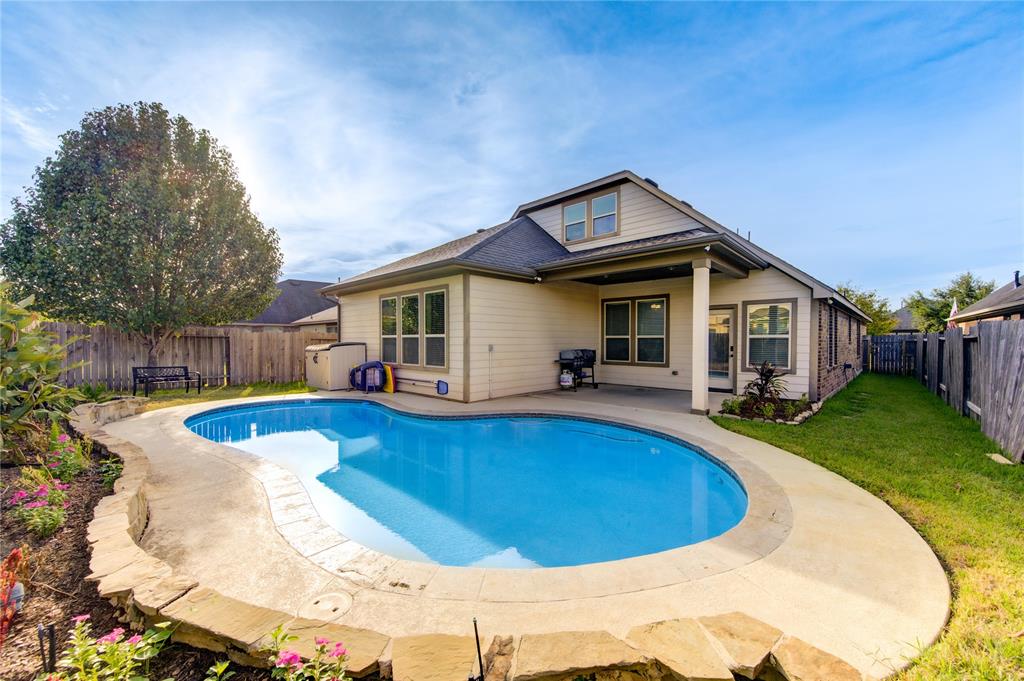 a view of house and outdoor space with swimming pool and furniture