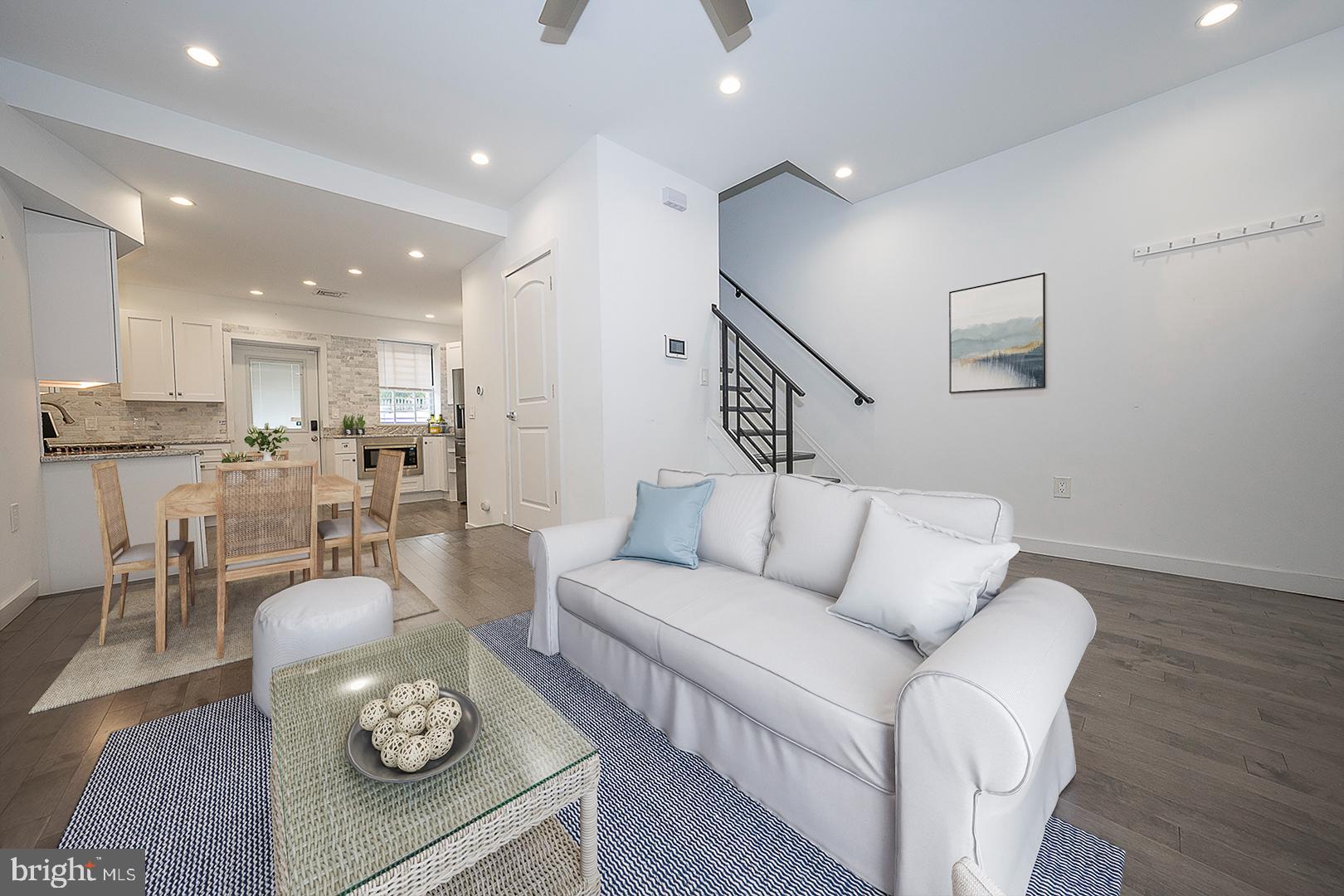 a living room with furniture and kitchen view