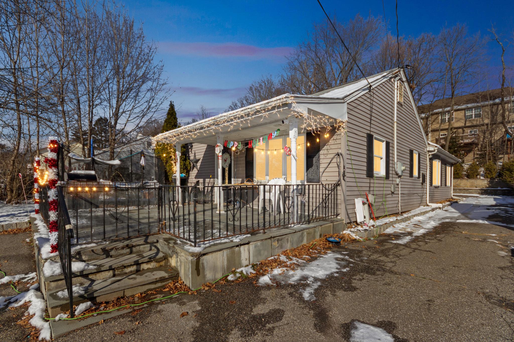 View of snow covered exterior featuring covered porch