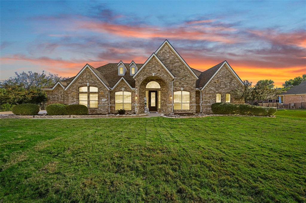 a view of a big yard with a house in the background