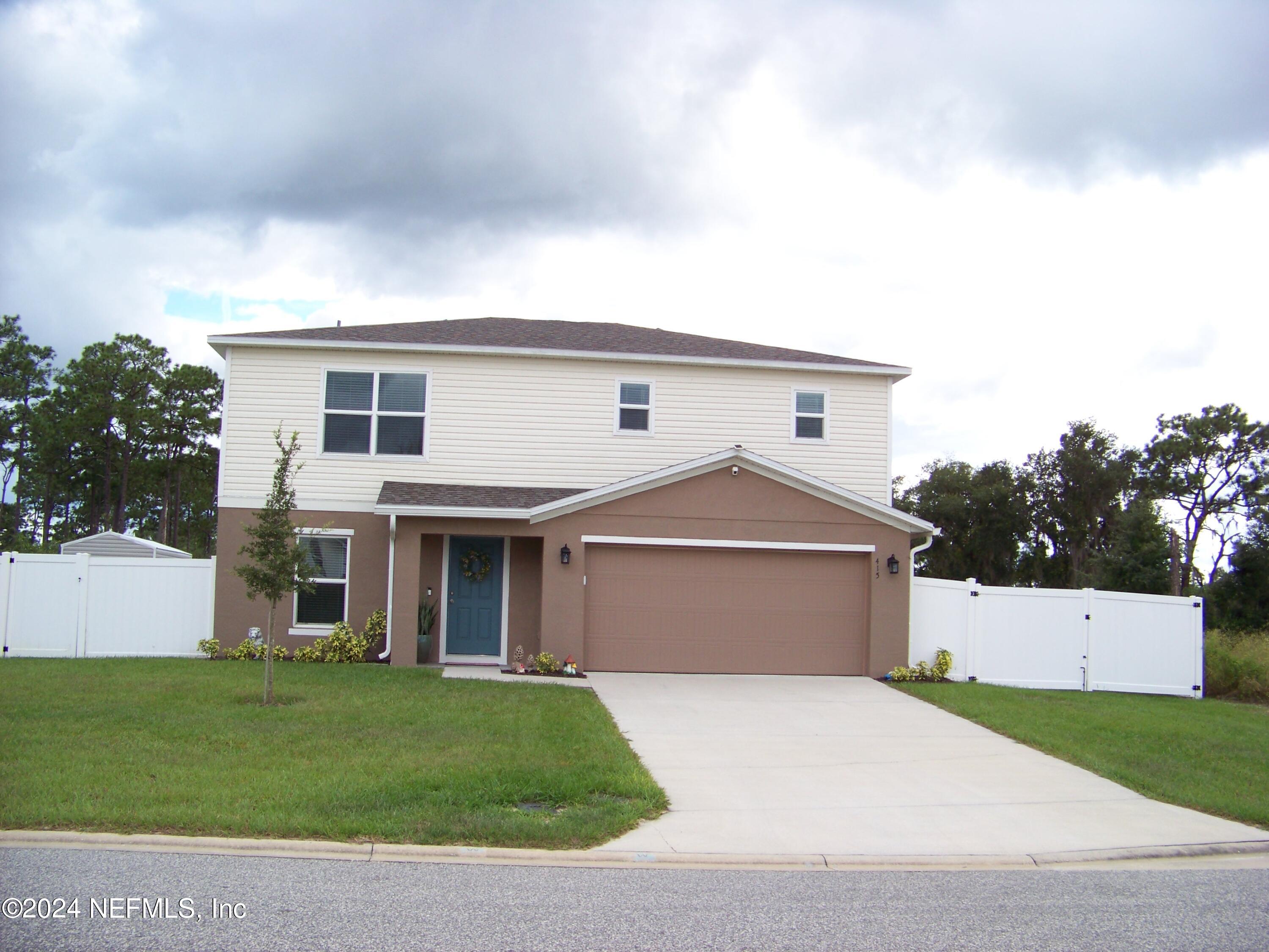 front view of a house with a yard