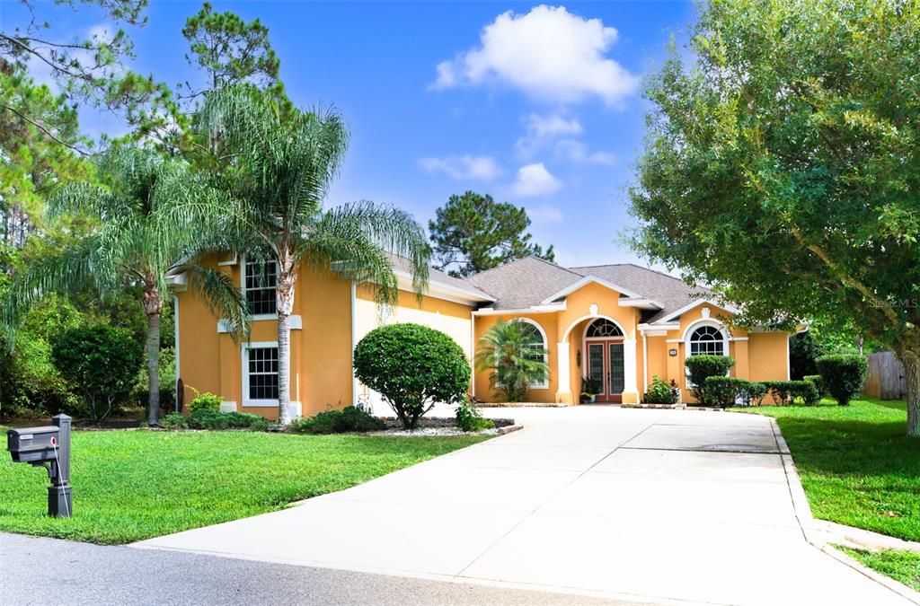 a front view of house with yard and green space