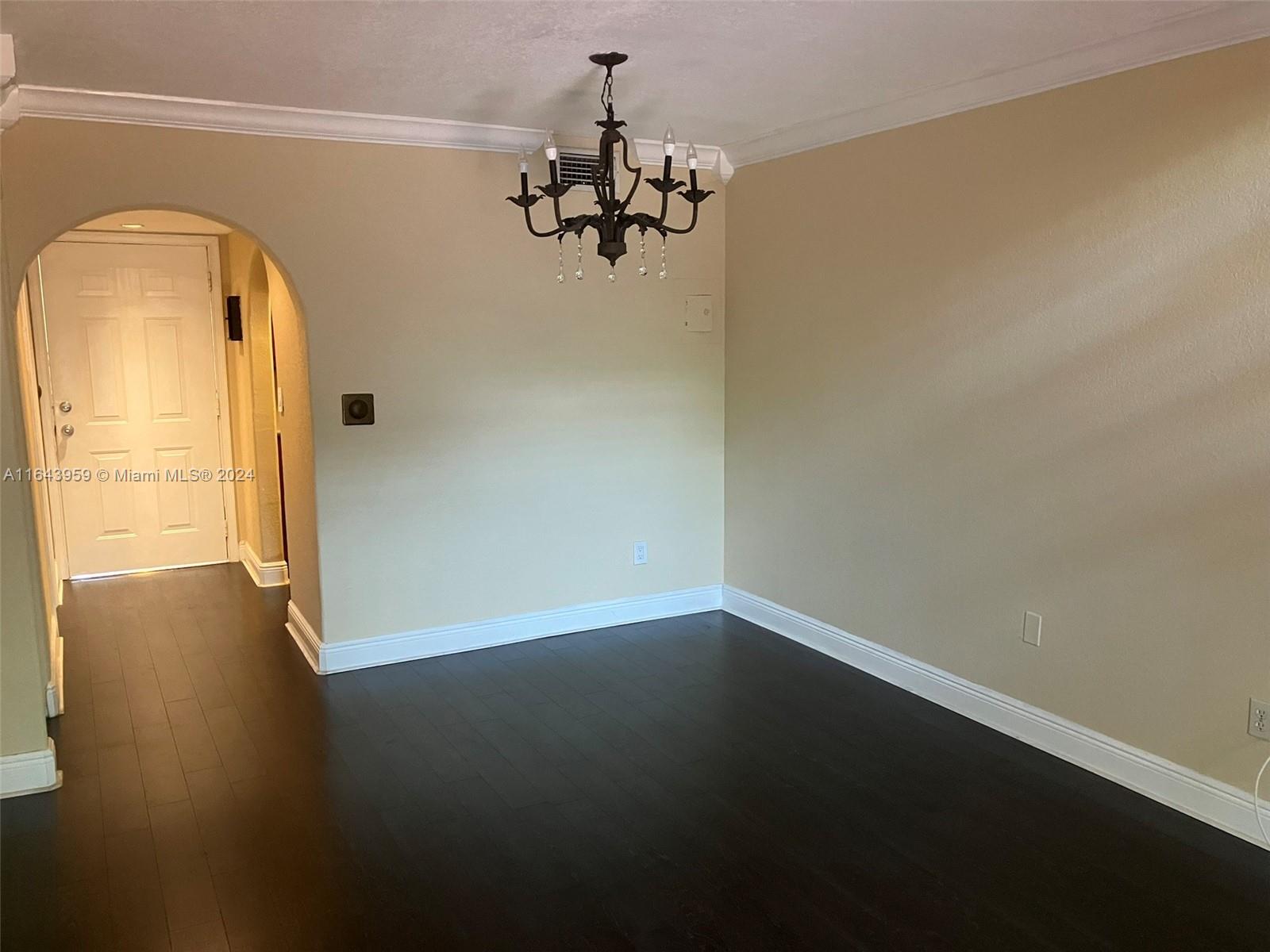 a view of a chandelier in big room and a chandelier