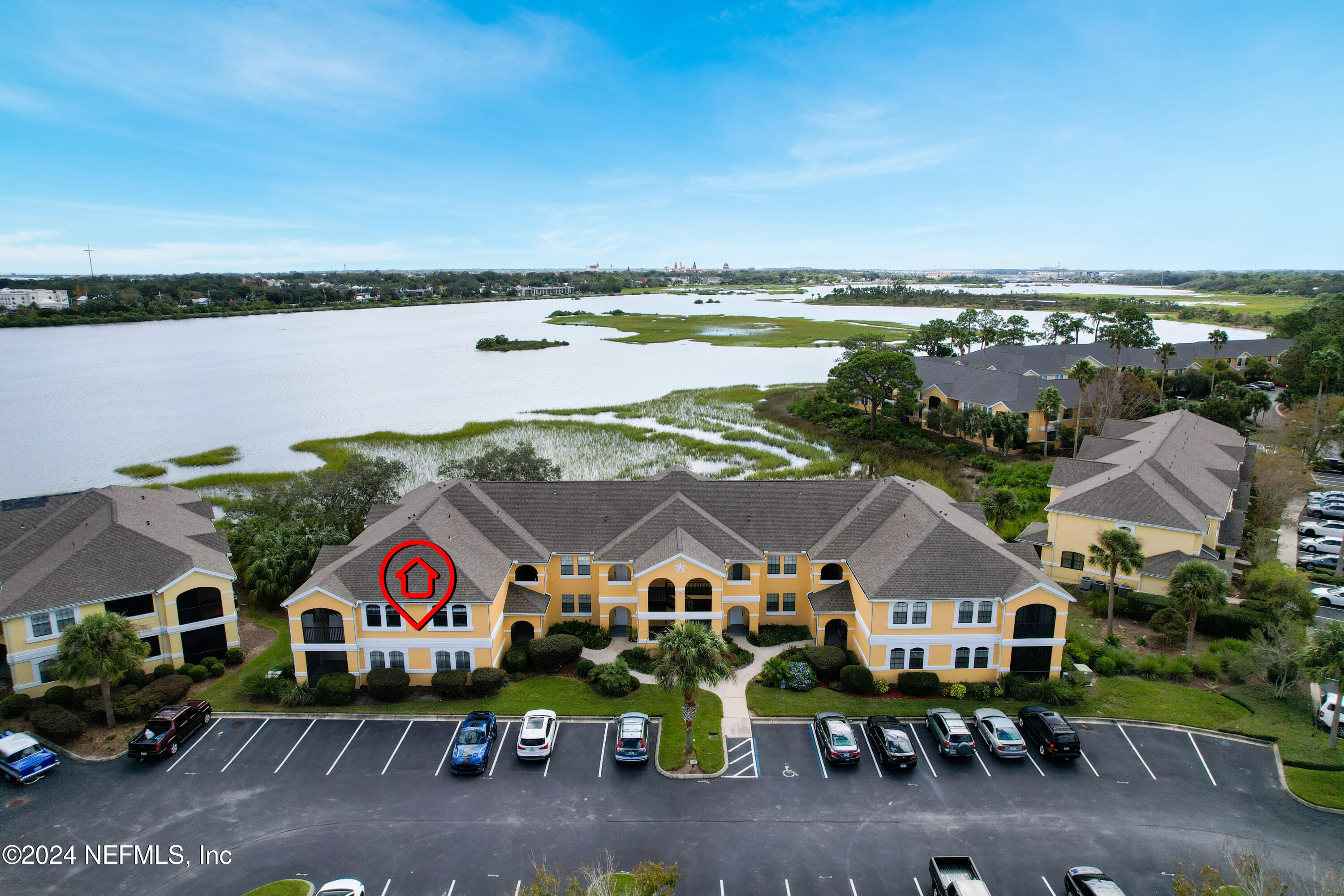 an aerial view of residential houses with outdoor space and swimming pool