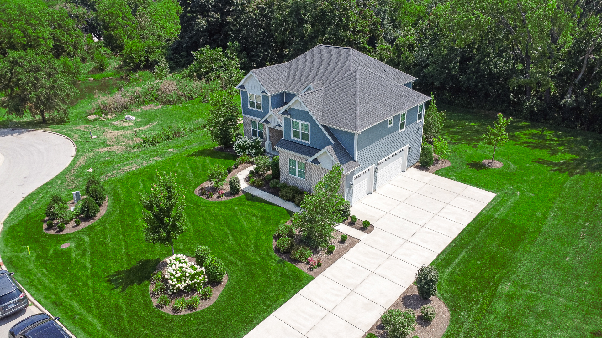 a aerial view of a house with a yard and trees