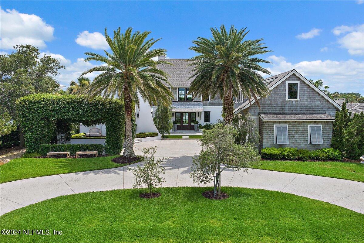 a front view of house with yard and green space