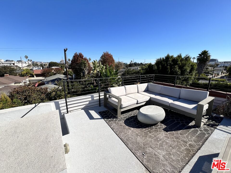 a view of a terrace with furniture and a fire pit