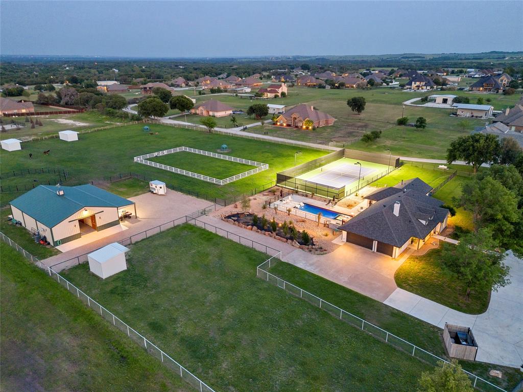 an aerial view of a house with a garden and swimming pool