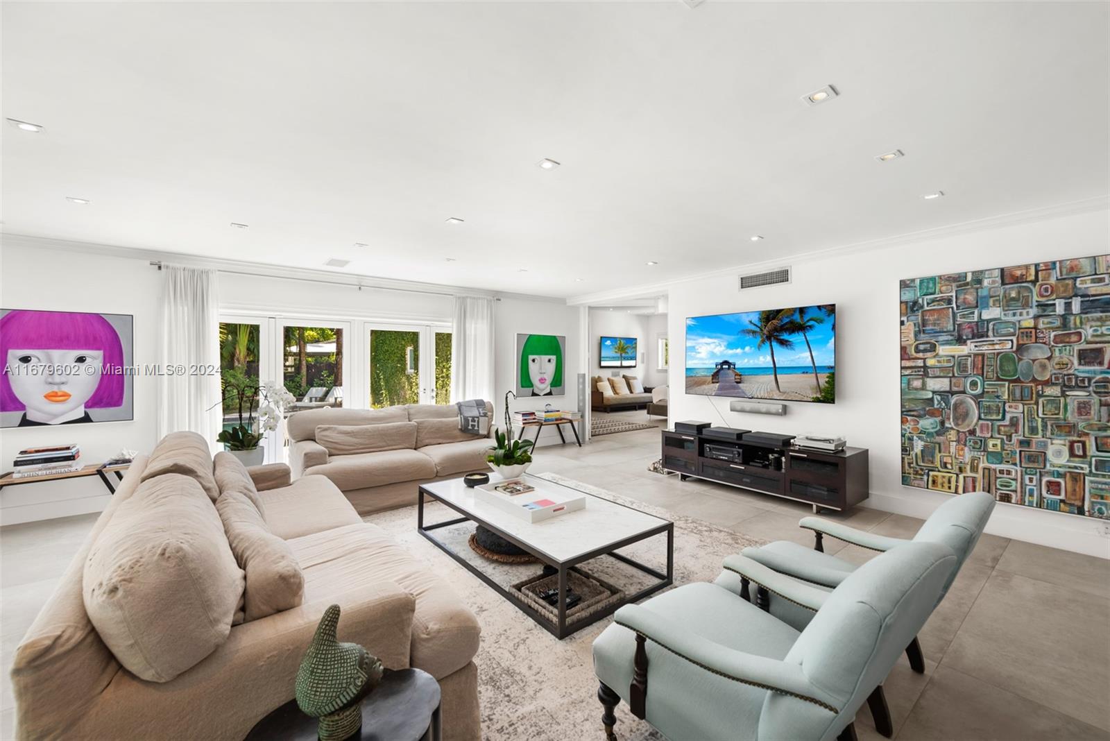 a living room with furniture a rug and a flat screen tv