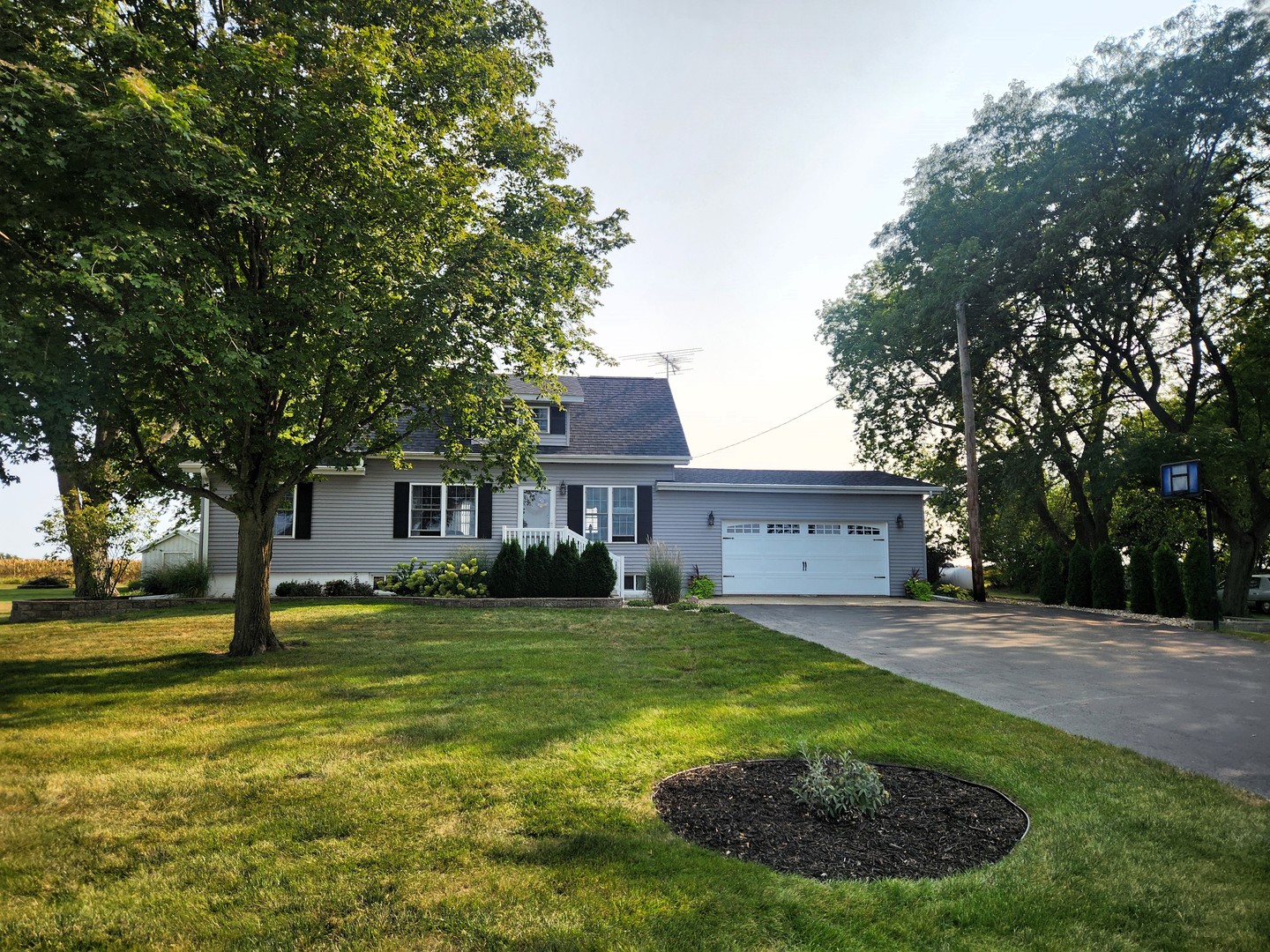 a house view with a sitting space and garden