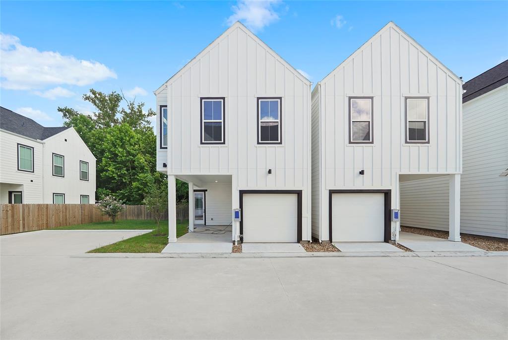 a view of house with yard and parking space