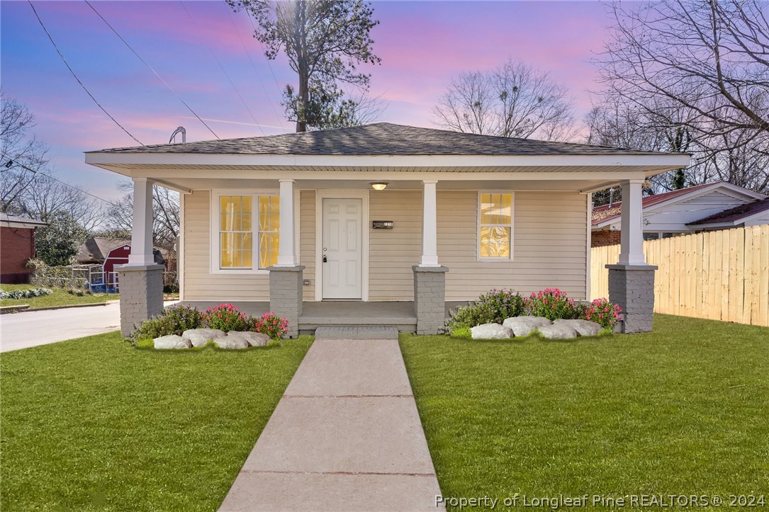 a front view of a house with a garden and plants