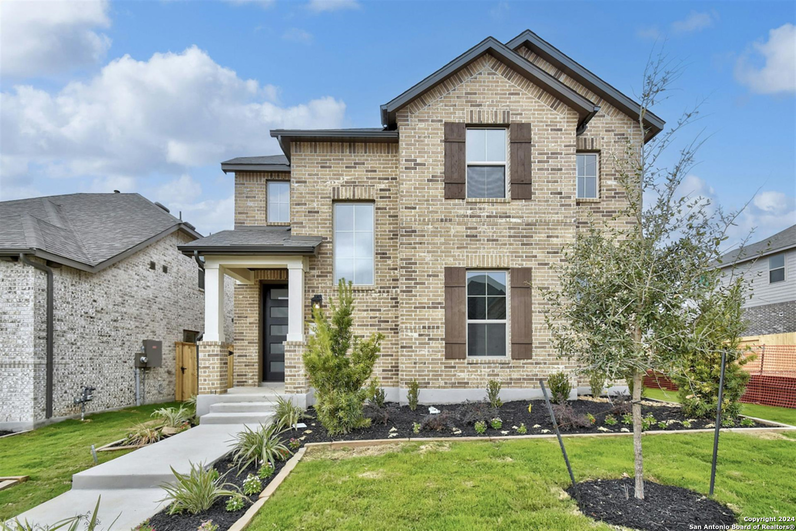 a front view of a house with a yard