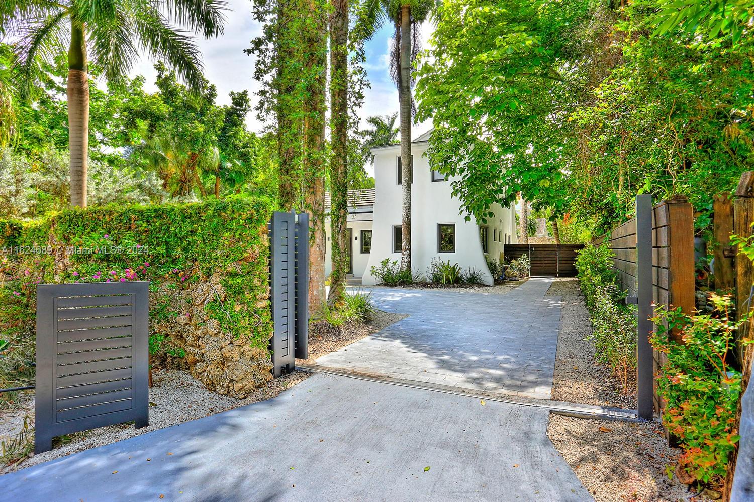 a view of a house with a tree and plants