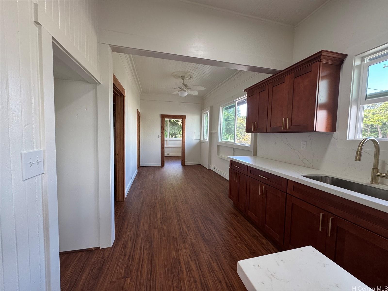 a kitchen with wooden floors and wooden cabinets