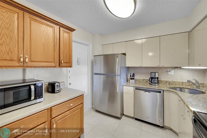 a kitchen with appliances cabinets and a sink