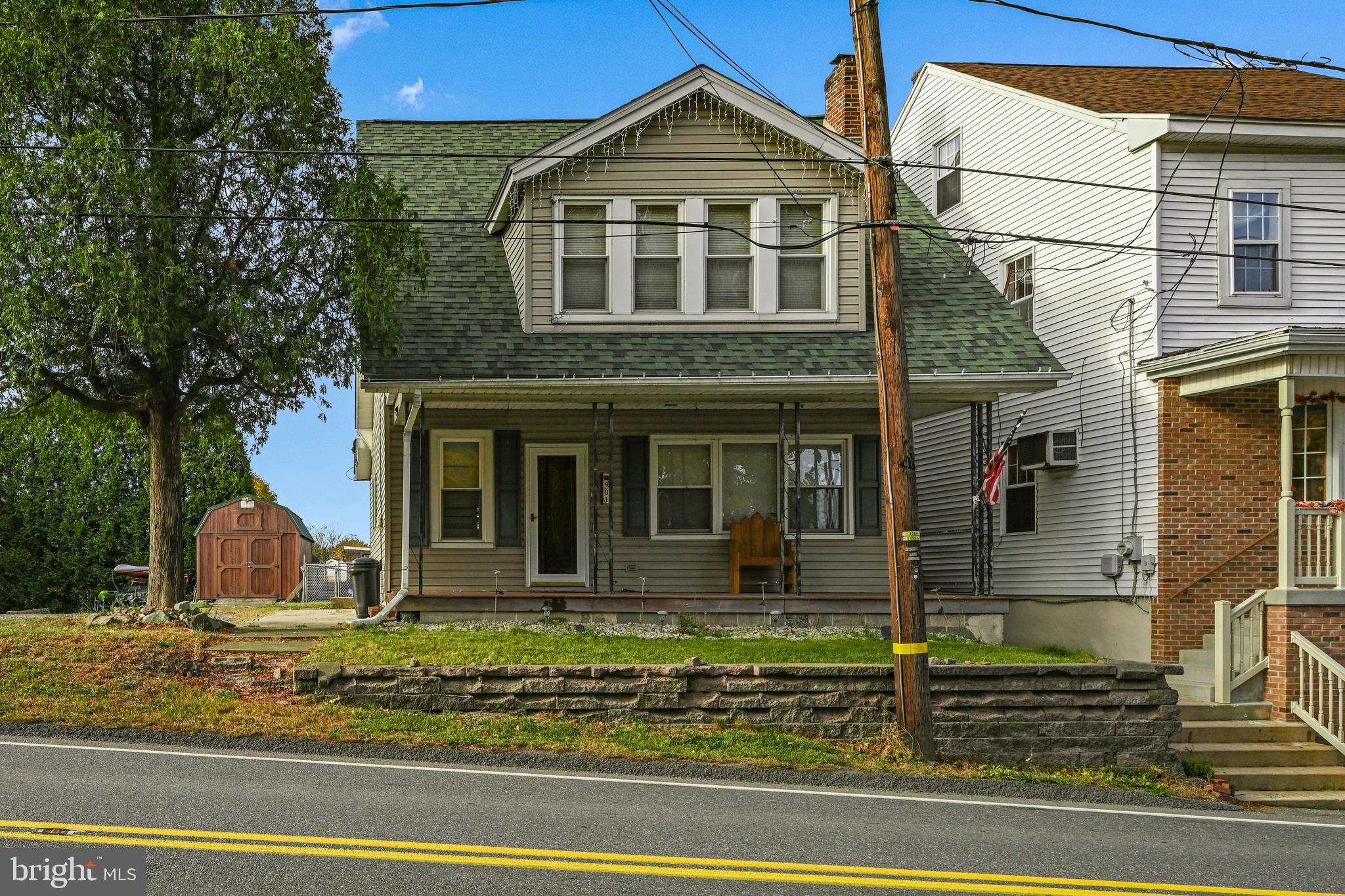 a view of a brick house with lots of windows and plants