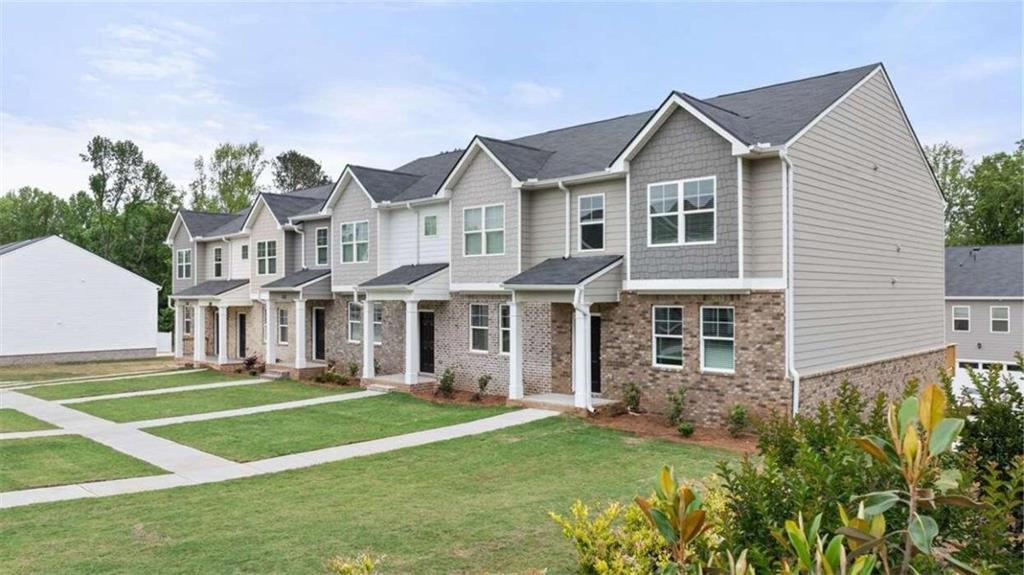 a front view of a house with a yard