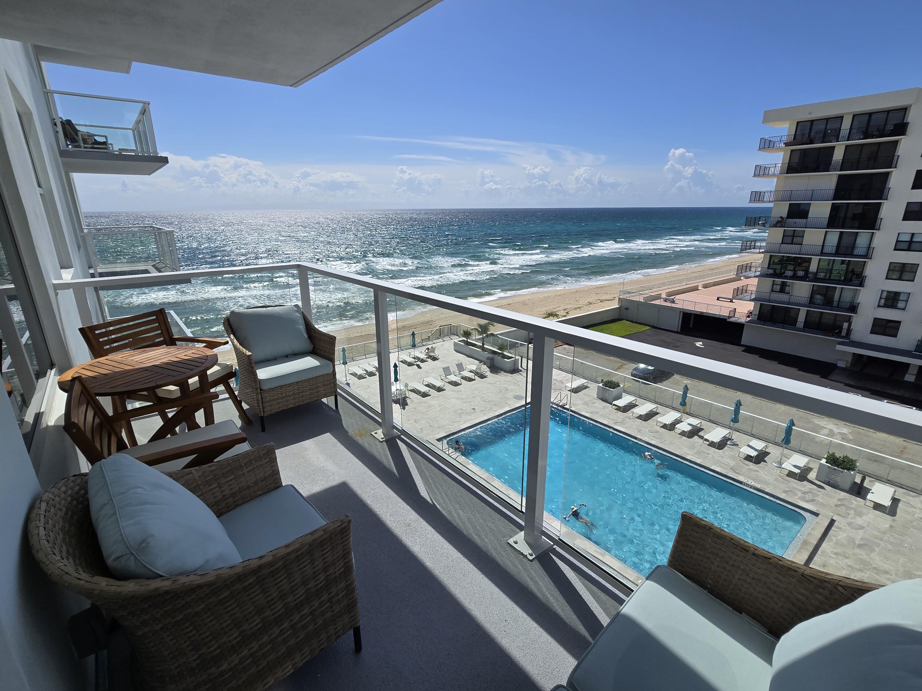 a roof deck with couch and outdoor view