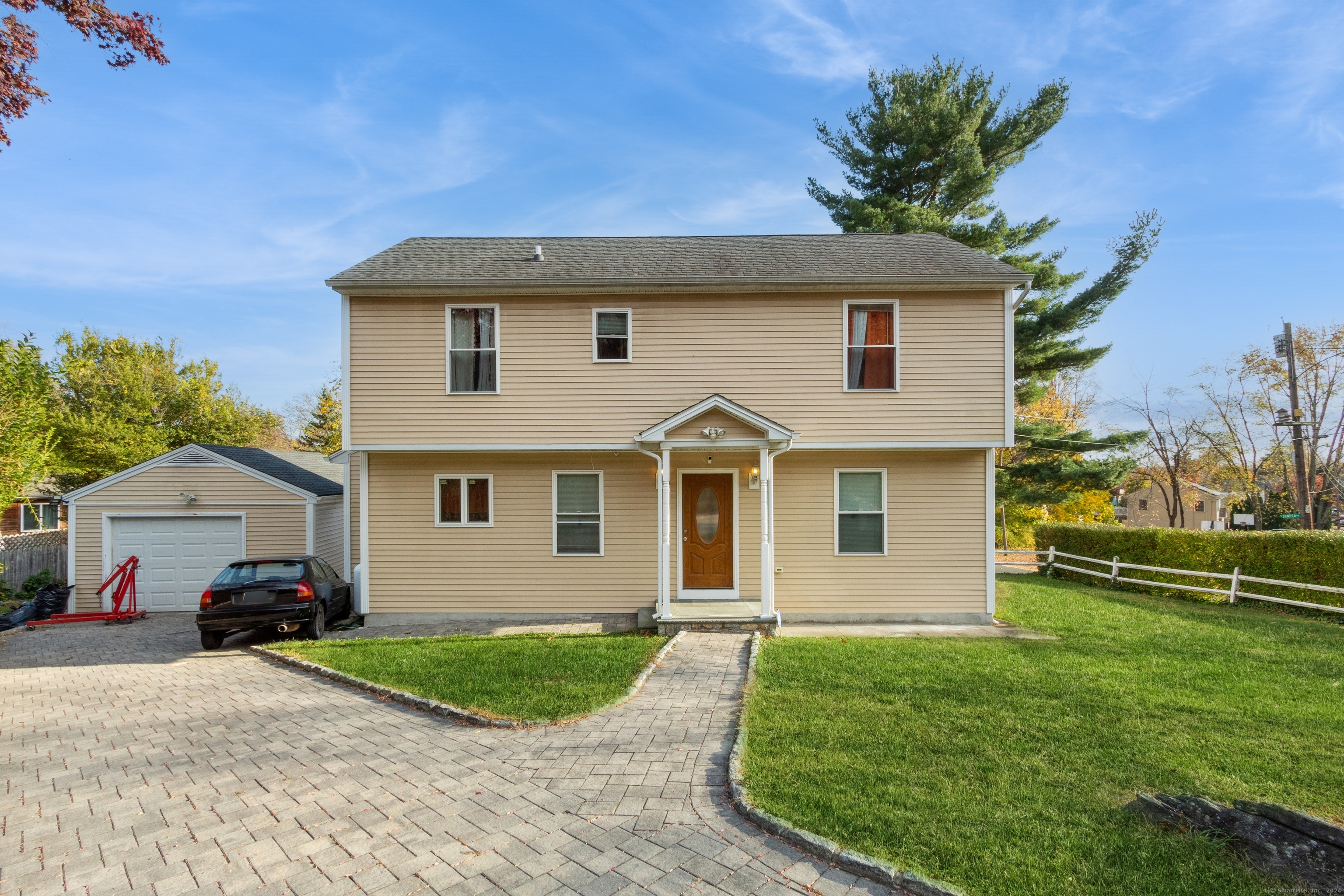 a front view of a house with a garden