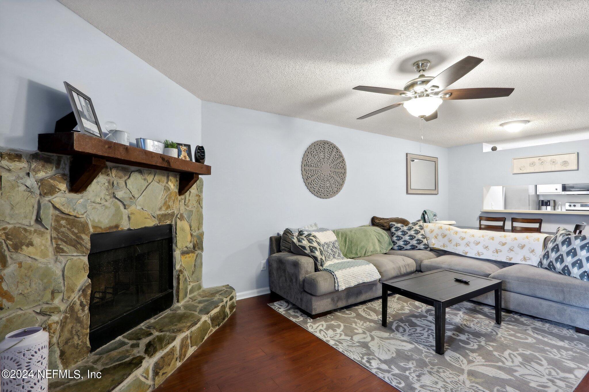 a living room with furniture a rug and a fireplace