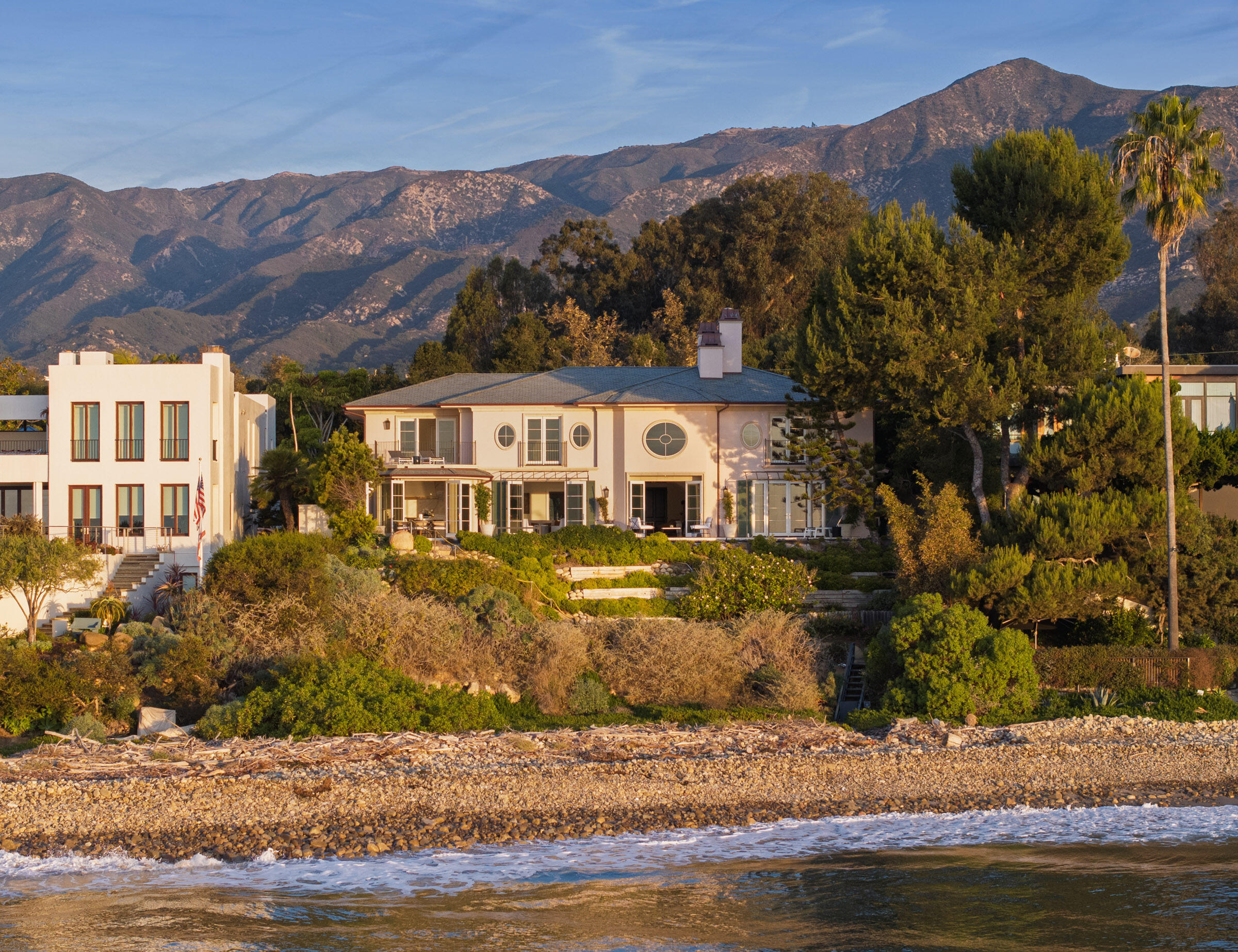 a view of a house with a yard and mountains