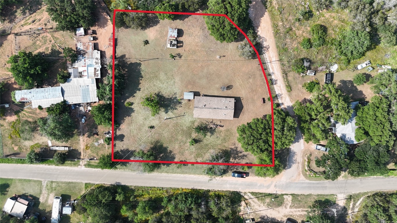 an aerial view of a house with a yard and garden