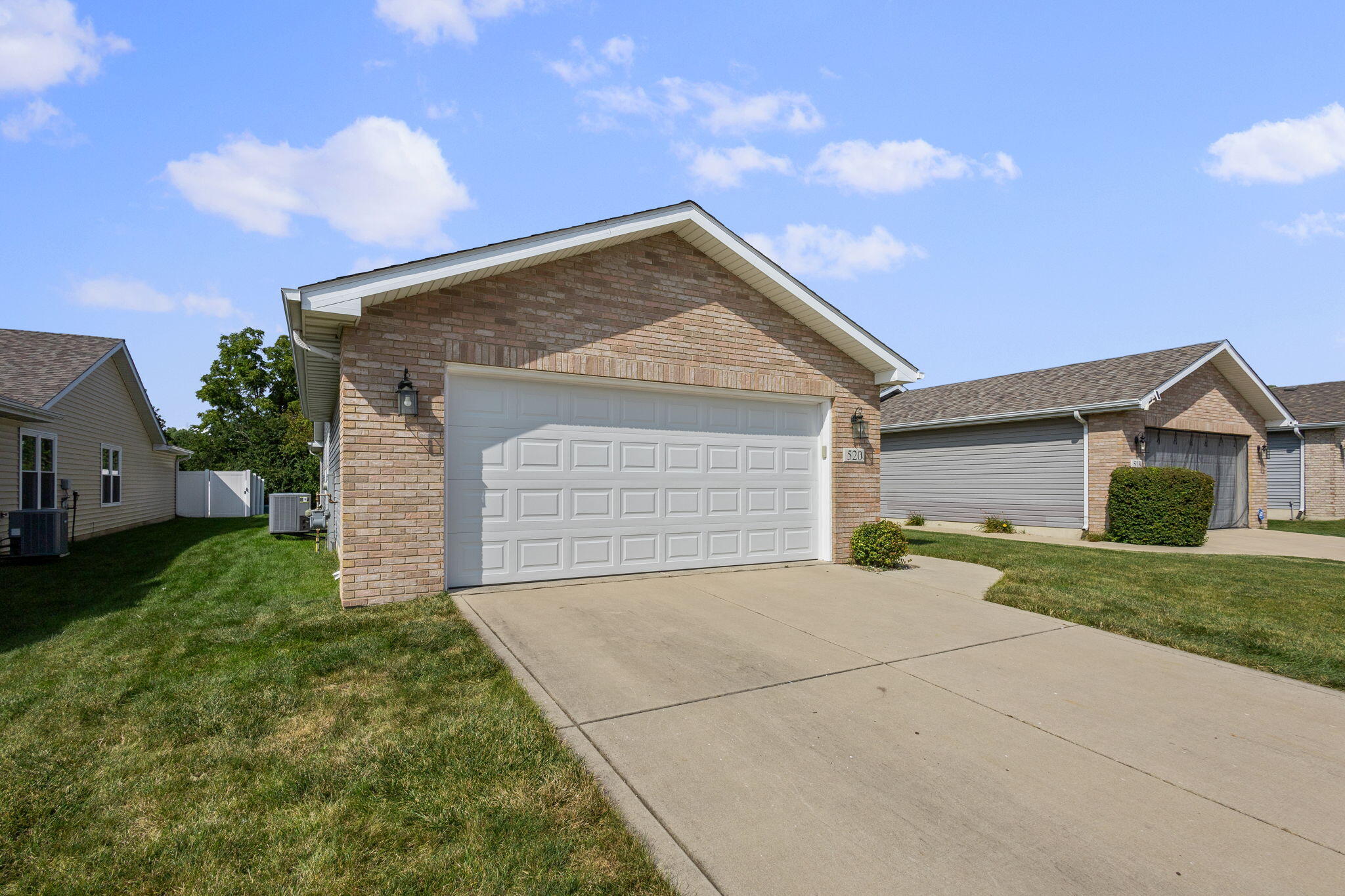 a view of a house with a yard and garage