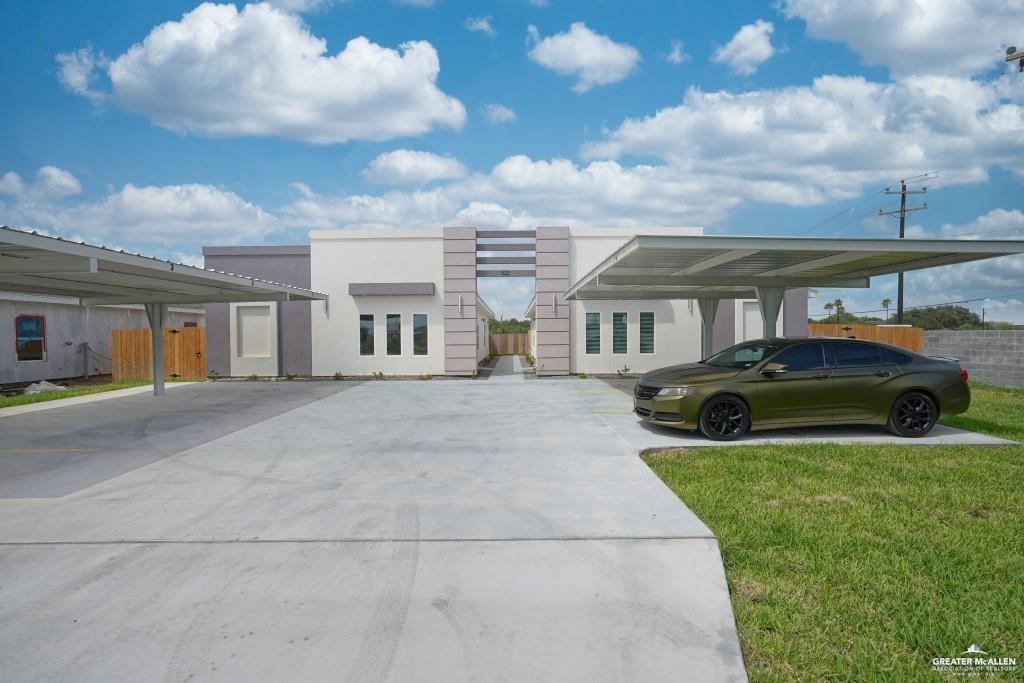 View of front of house featuring a front lawn and a carport