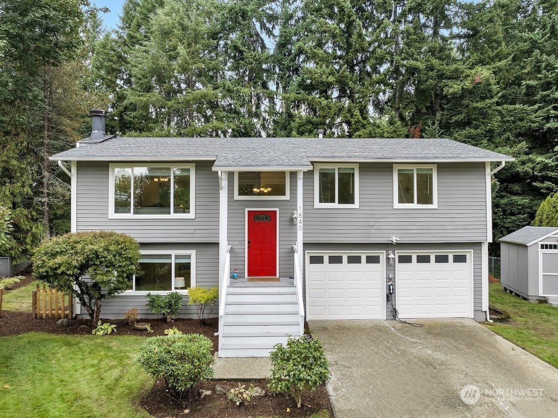 a front view of a house with a yard garage and outdoor seating