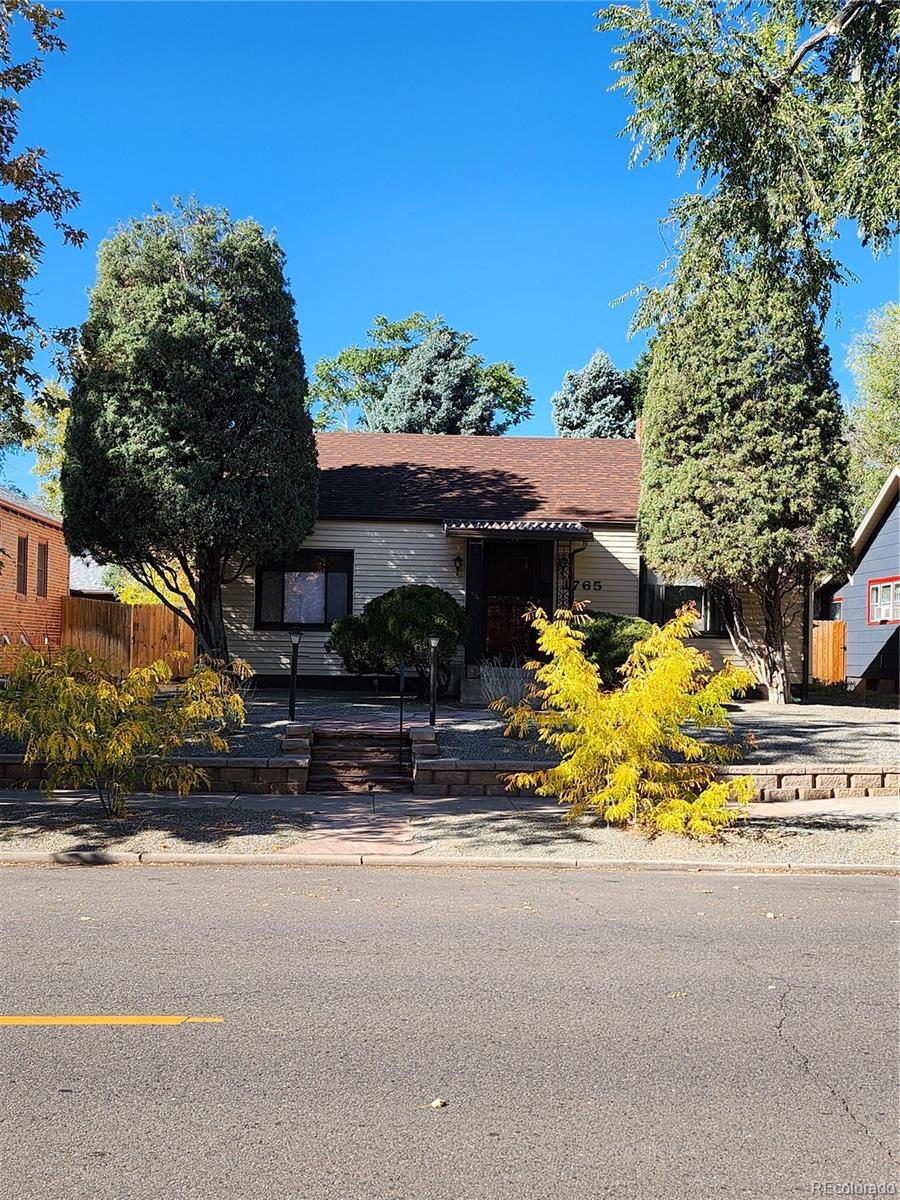 a view of a house with a yard and tree s