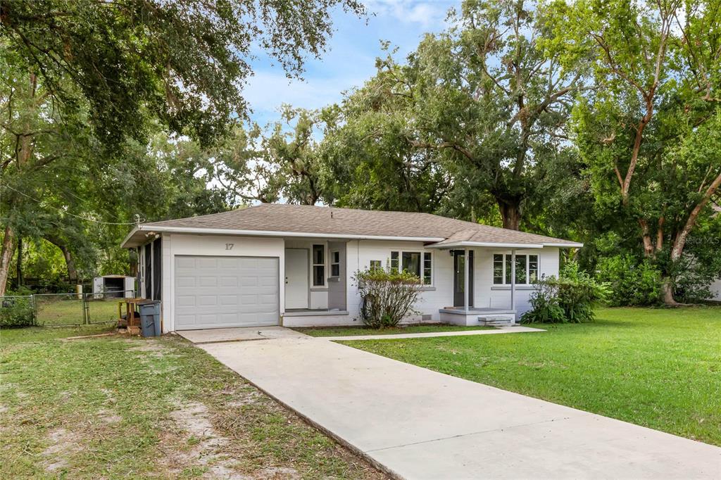 a front view of house with yard and green space