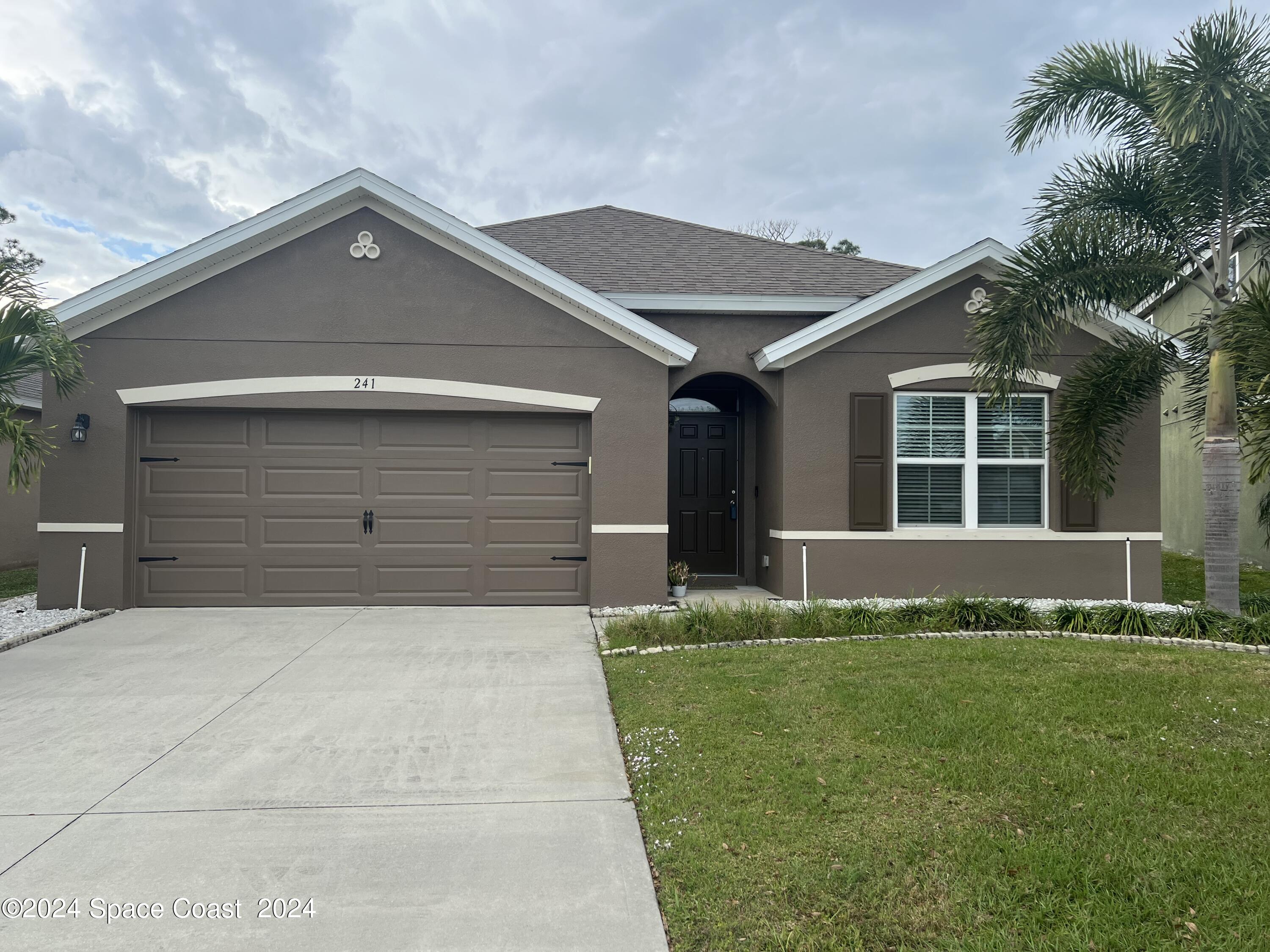 a front view of a house with a yard