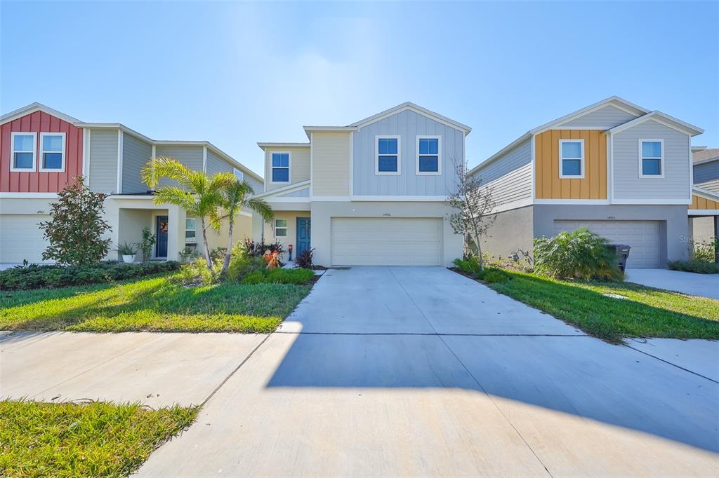 a front view of a house with a yard and garage