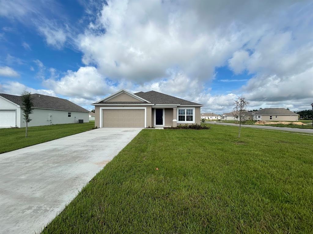 a front view of house with yard and green space